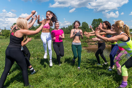 Group of fit womem runners finishing People applauding