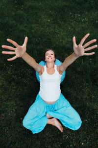 Happy pregnant yoga prenatal maternity doing different exercises with fitball. in park on the grass, breathing, stretching, forest. concept of healthy lifestyle and relaxation. Pilates. top view.