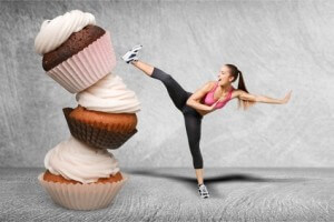 Fit young woman fighting off fast food