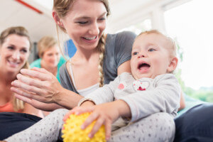 Mum and her baby child in pregnancy recovery course exercising