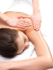 Massage therapy and hands massaging - Portrait of a pretty young girl getting a massage at the day spa